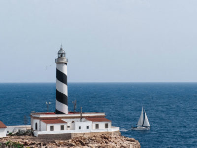 Cala Figuera lighthouse with sailing yacht