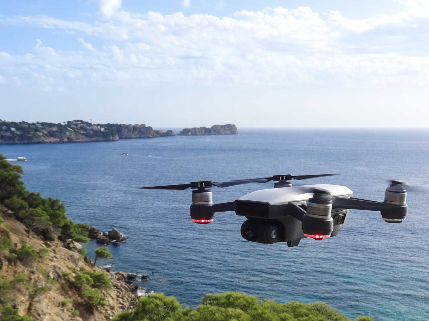 DJI spark drone flying above water